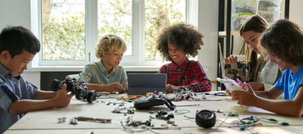 Multiracial,School,Kids,Students,Making,Robotic,Cars,Using,Tablet,Computer.