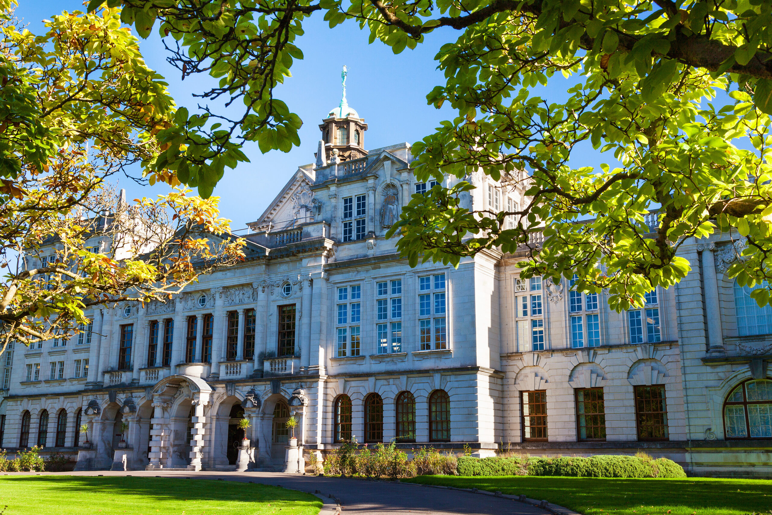 spring landscape of Cardiff University, main building behind the tree leaves in Wales, UK