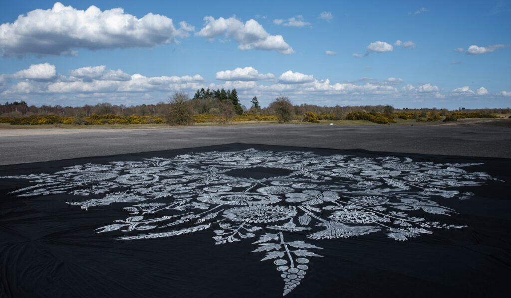 "Where Have All the Flowers Gone?" – An Anti-War Artwork by Street Artist 742 Appears on the Runway of the Former RAF Greenham Common | London Cult.