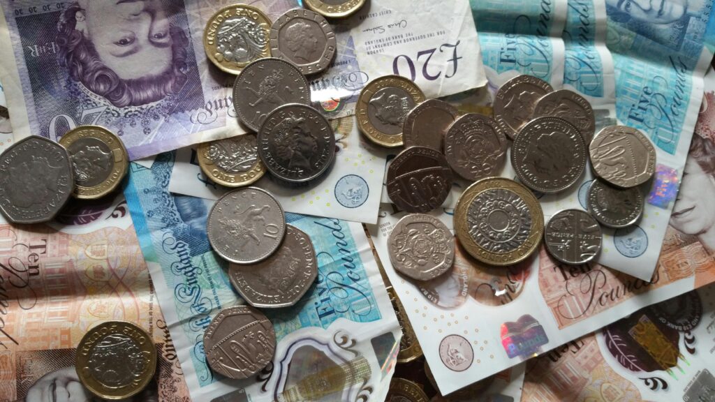 Round Coins on Paper Bills of British Pounds