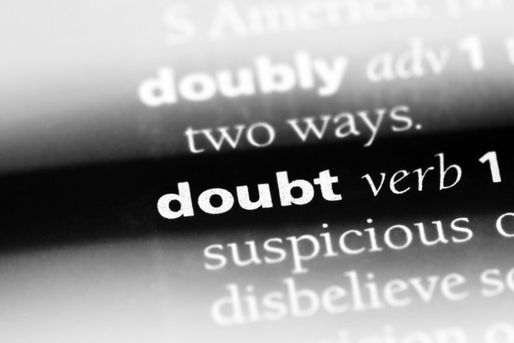 black and white photo of a "doubt" word in a dictionary.