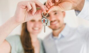 Happy Couple Holding and Showing a House Key