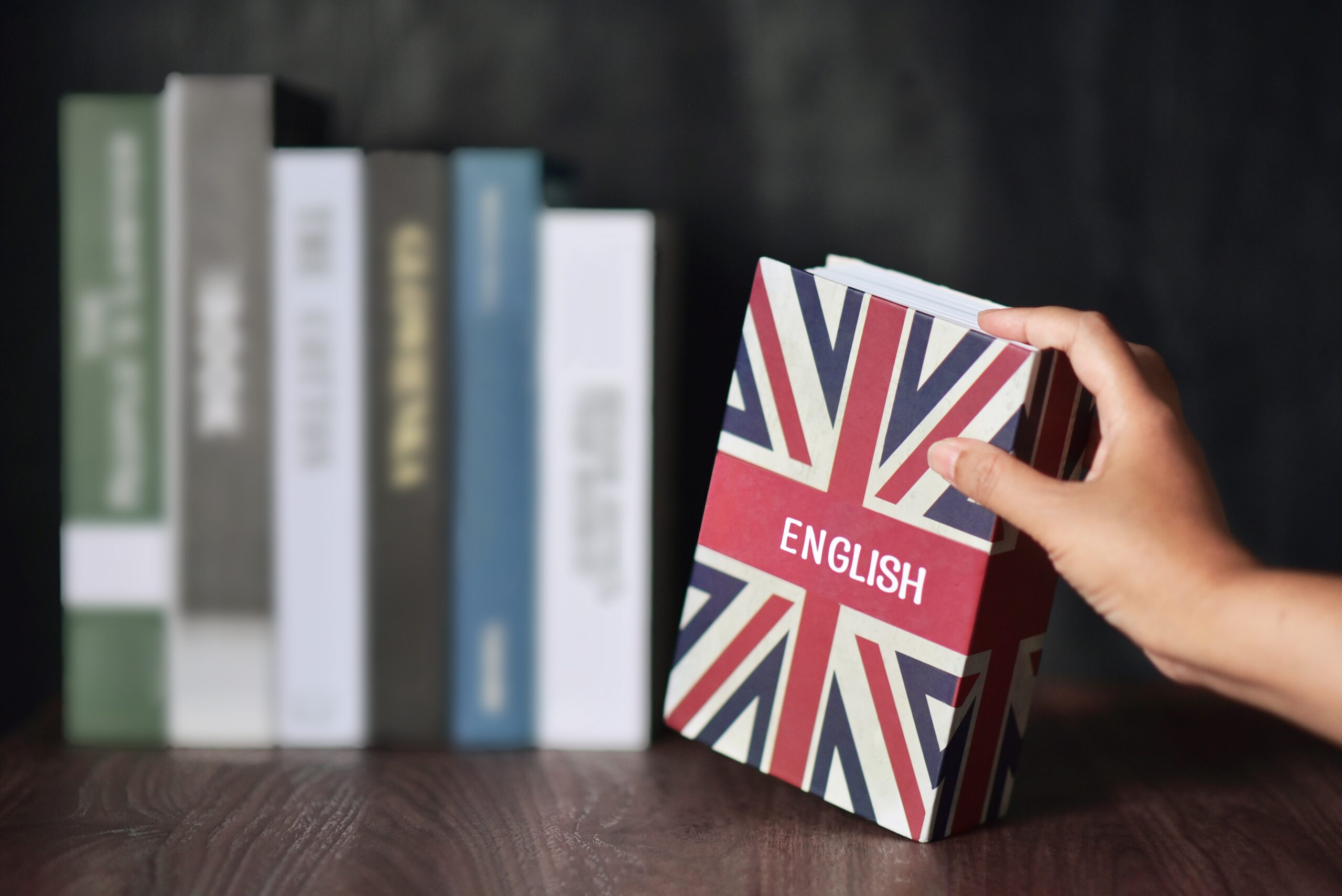English book is selected from the bookshelf. Learning English fluently are advantages such as can connect to the foreigner, new bussiness, make more money, Increased Brainpower and Immigration Benefit