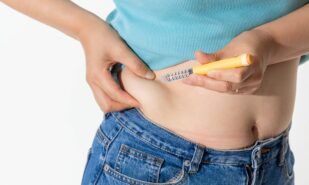 A woman injecting herself with obesity medication