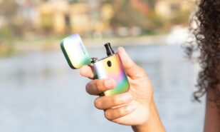 Girl holding small pod vape for vaping