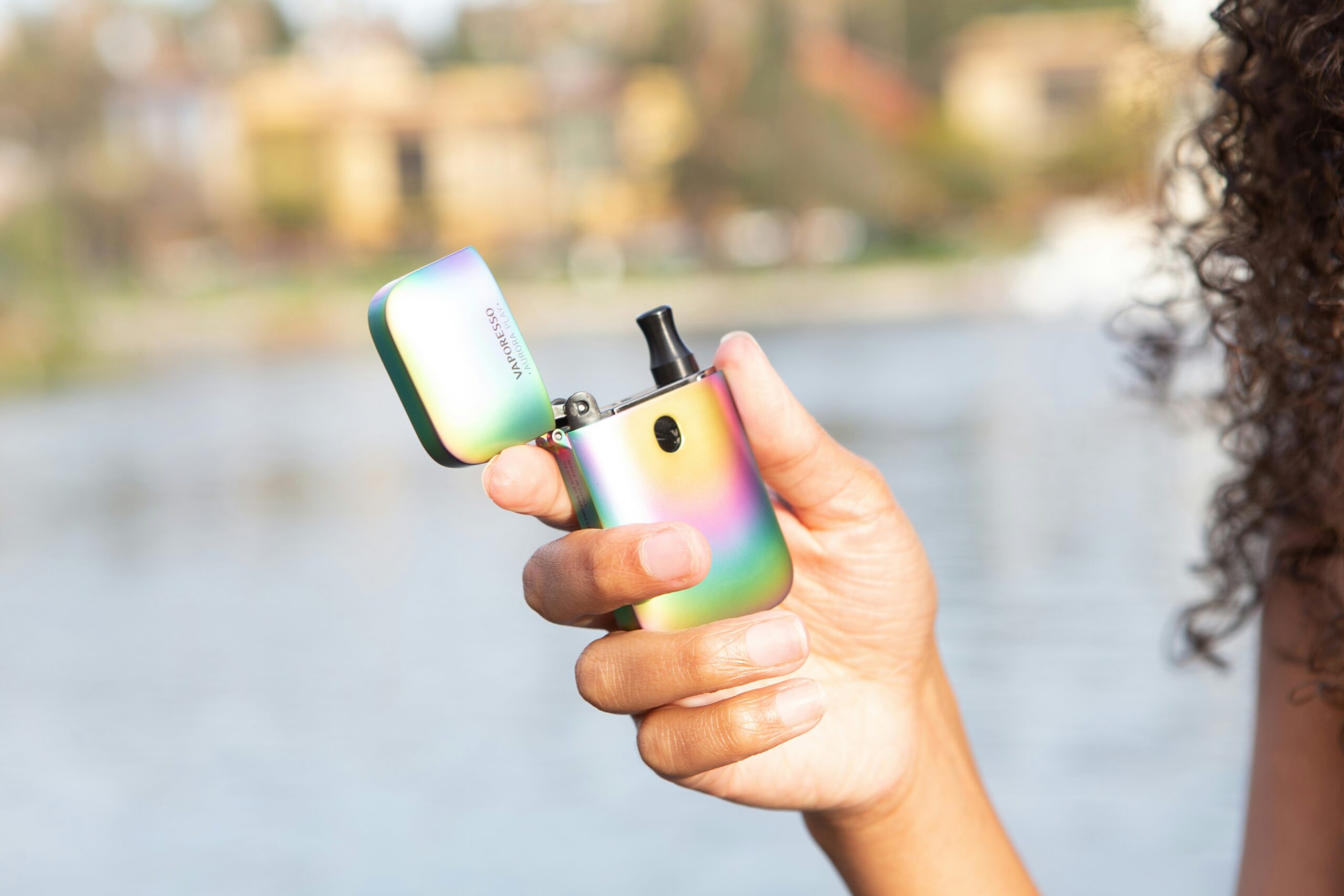 Girl holding small pod vape for vaping