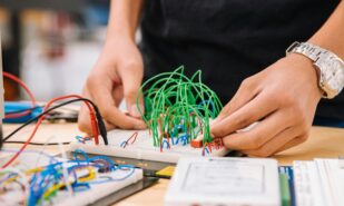 person holding green ball on white paper, technology, computer, school, and education