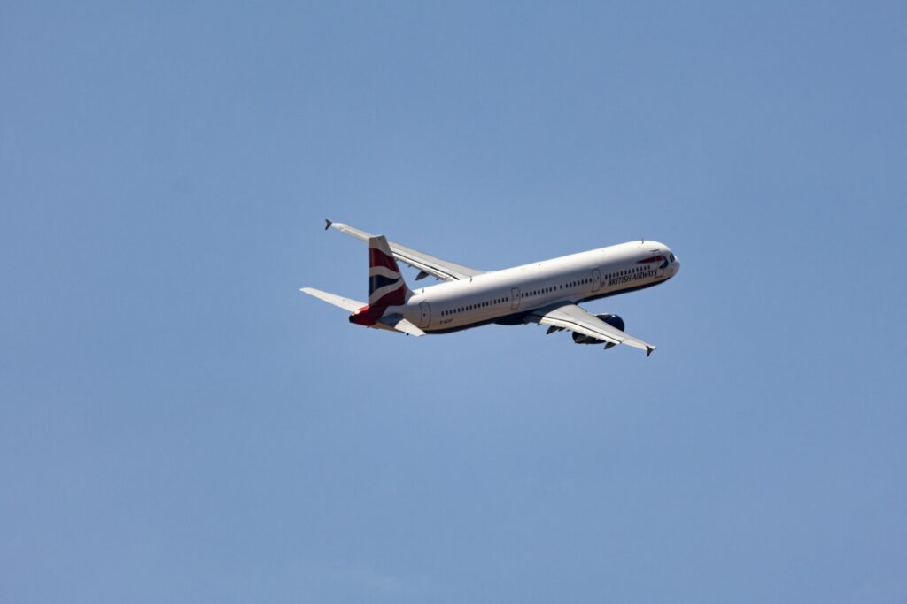 Commercial Airplane in Flight Against Clear Sky