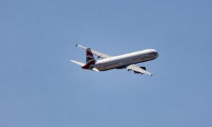 Commercial Airplane in Flight Against Clear Sky