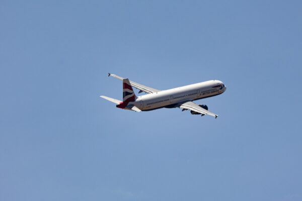Commercial Airplane in Flight Against Clear Sky