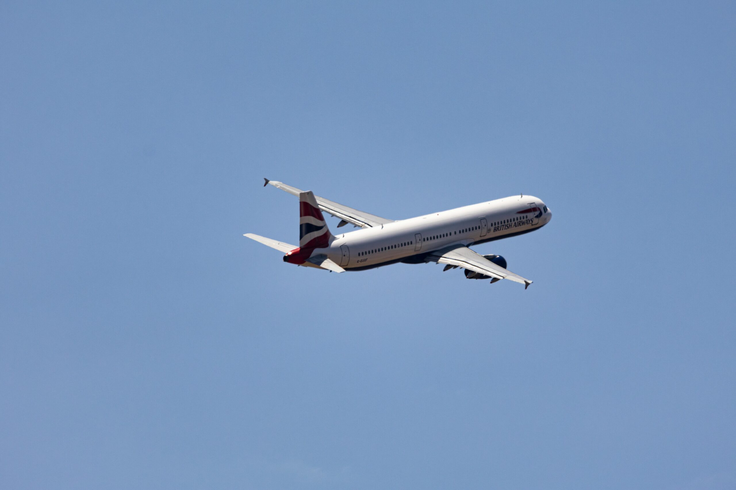 Commercial Airplane in Flight Against Clear Sky