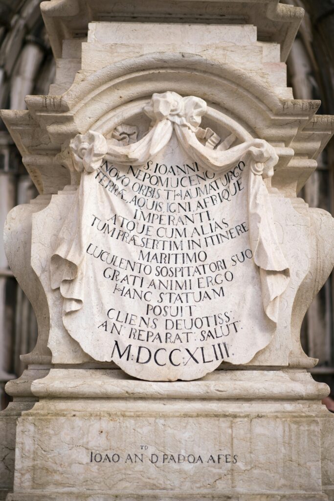 Part of pedestal of statue of St John of Nepomuk with latin text