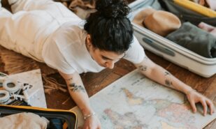 Pretty Woman Lying on the Floor Holding a Map