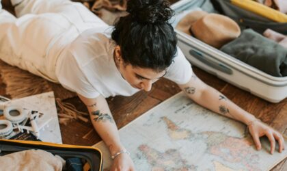 Pretty Woman Lying on the Floor Holding a Map