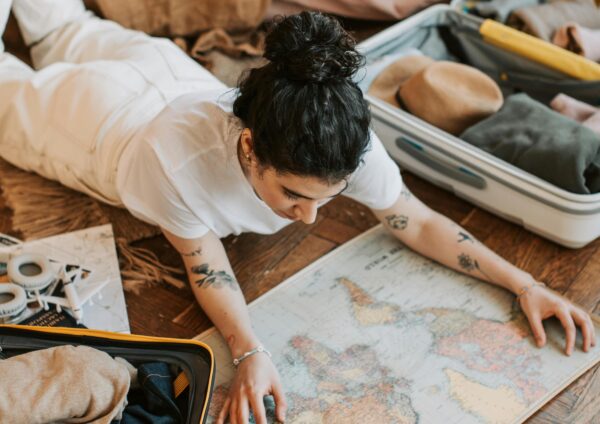 Pretty Woman Lying on the Floor Holding a Map