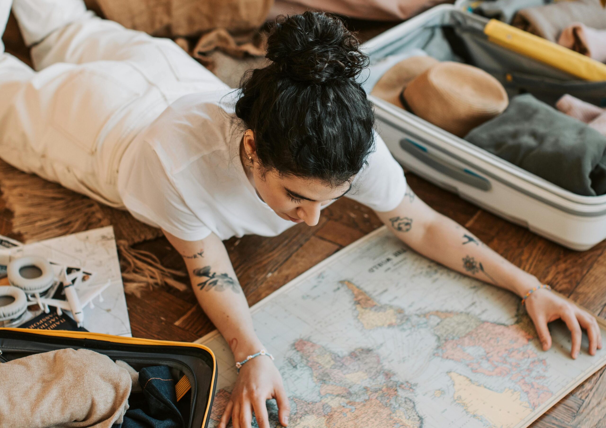 Pretty Woman Lying on the Floor Holding a Map