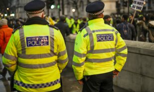 london police work near government house during protests