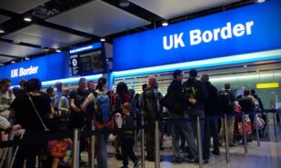 Air travellers queue at border passport control entrance gates at Heathrow Airport on August 24, 2018 in London, UK. The British aviation hub is the world's busiest by international passenger traffic.