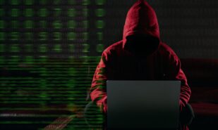 Hacking and malware concept. Hacker using laptop computer with binary code digital interface. Double exposure.