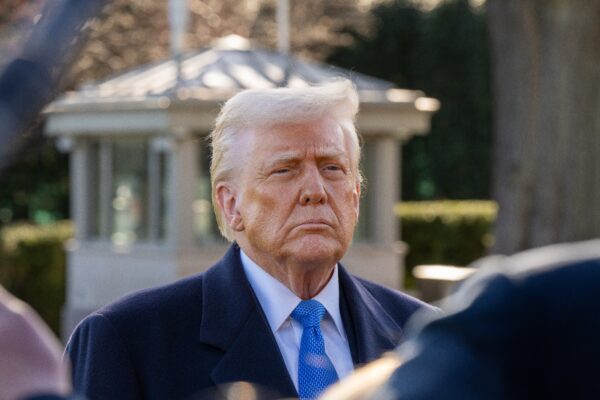 President Donald Trump stops to speak with media