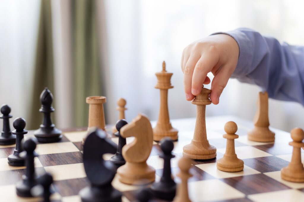 little boy is playing chess at home. High quality photo