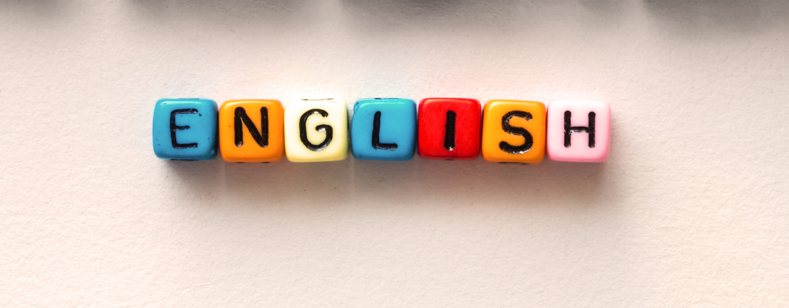 Colorful,English,Word,Cube,On,White,Paper,Background,,english,Language