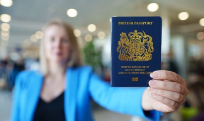 Woman showing passport of United Kingdom.