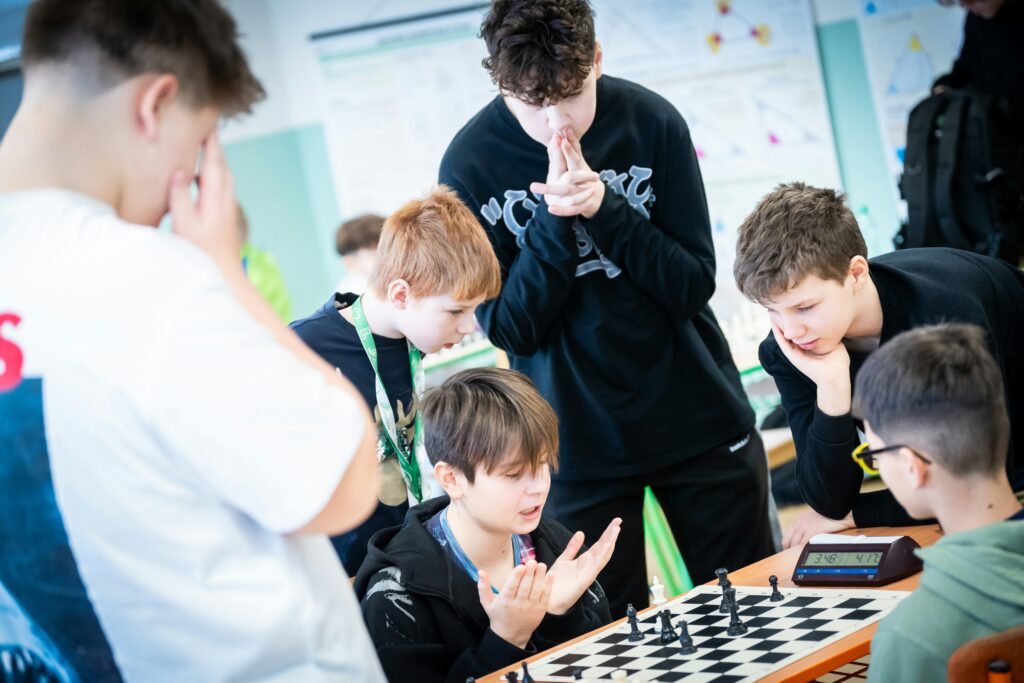 A group of young men playing a game of chess