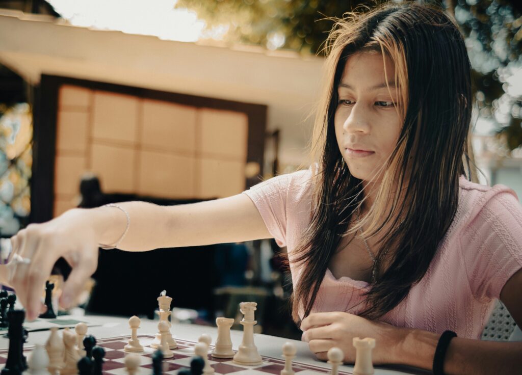 A woman playing a game of chess