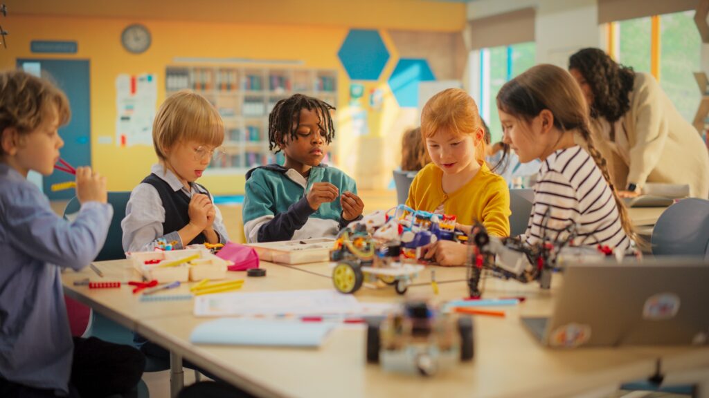 Smart Boys and Talented Girls Playing with Scientific and Engineering Toys. Young Gifted Future Engineers Studying Science, Engineering, Math and Technology in Primary STEM School