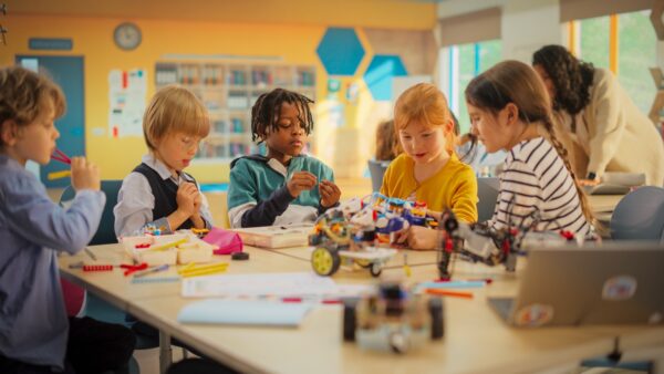 Smart Boys and Talented Girls Playing with Scientific and Engineering Toys. Young Gifted Future Engineers Studying Science, Engineering, Math and Technology in Primary STEM School