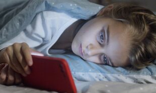 A Girl Watching Something on Her Smartphone