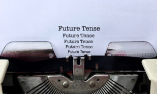 FUTURE TENSE, words typewritten several times on white paper on vintage old fashioned typewriter machine with copy space