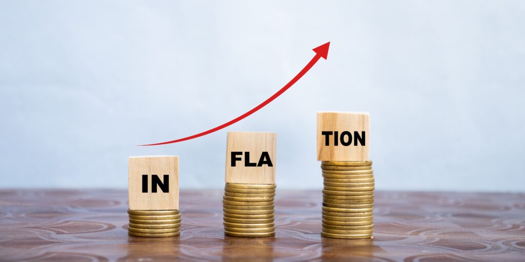 inflation word on wooden cube coins in idea for RBI consider interest rate hike, world economics, and inflation control concept