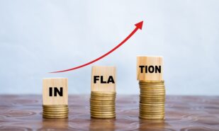 inflation word on wooden cube coins in idea for RBI consider interest rate hike, world economics, and inflation control concept