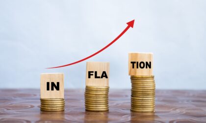 inflation word on wooden cube coins in idea for RBI consider interest rate hike, world economics, and inflation control concept