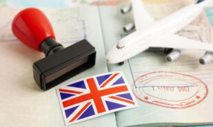 United Kingdom UK Visa flag and passport with airplane for travel.