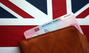 Residence Permit BRP card in purse on Union Jack flag close up