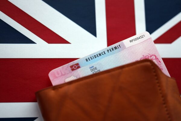 Residence Permit BRP card in purse on Union Jack flag close up