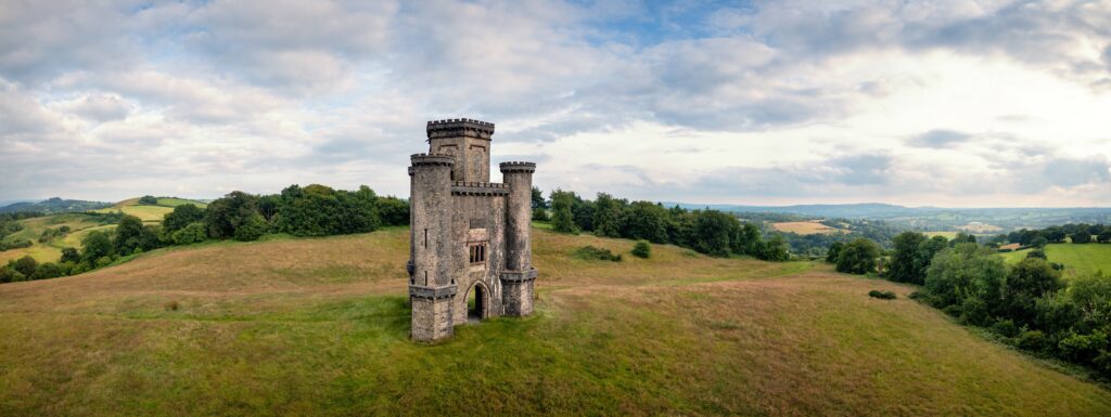 Panoramic aerial view of Paxton's Tower against blue cloudy sky. Llanarthne, Carmarthenshire, Wales, UK.