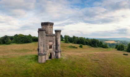 Panoramic aerial view of Paxton's Tower against blue cloudy sky. Llanarthne, Carmarthenshire, Wales, UK.