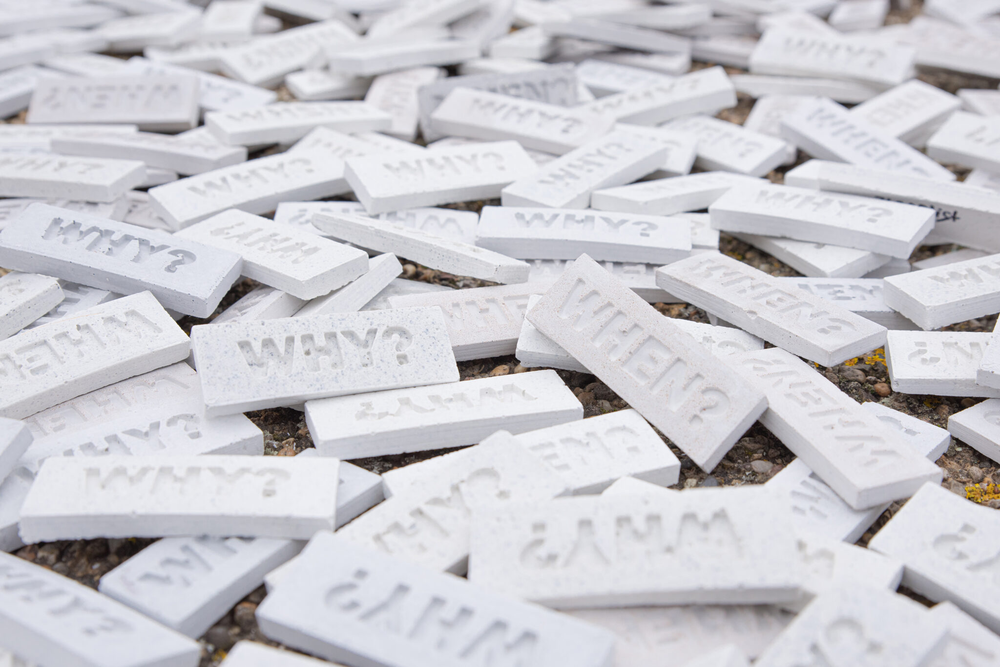 Tiles with the questions 'WHEN?' and 'WHY?' by artist 742