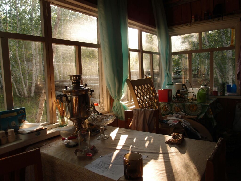 Sunlight falling through windows on table in country house.