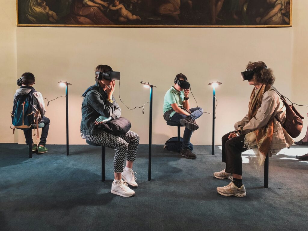 four people playing in virtual reality goggles vr