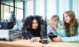 Children exploring how to use AI-powered robotic systems in science class, gaining future-ready skills through digital automation and real-world application.