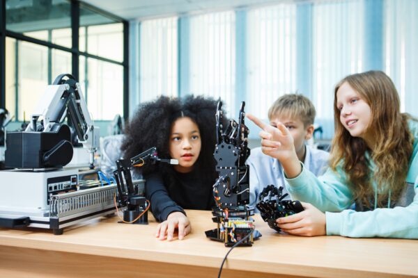 Children exploring how to use AI-powered robotic systems in science class, gaining future-ready skills through digital automation and real-world application.