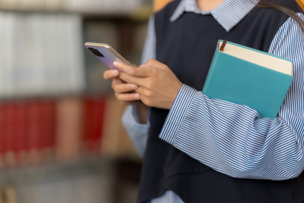 Asian woman chats with AI on mobile to enhance knowledge