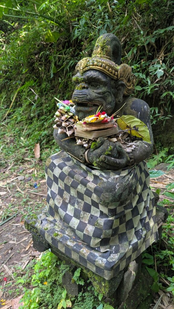 Statue of a deity with offerings on it, Bali, Indonesia