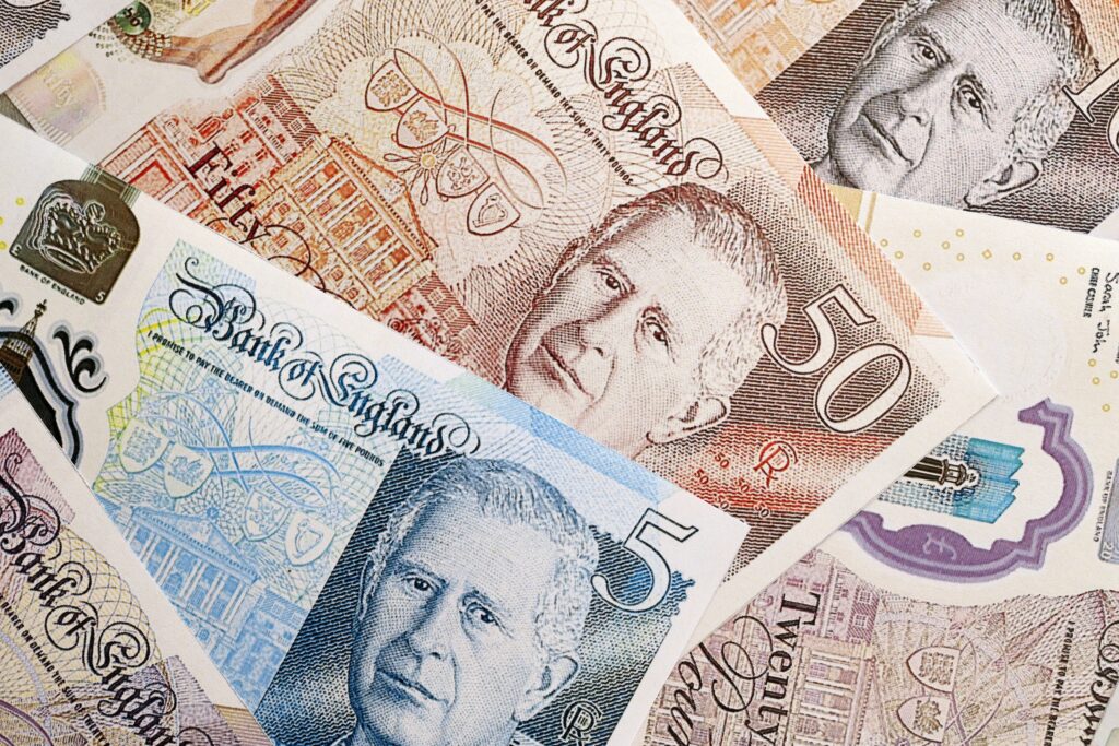 KYIV, UKRAINE - SEPTEMBER 17, 2025 Big pile of British pound money bills on table close up