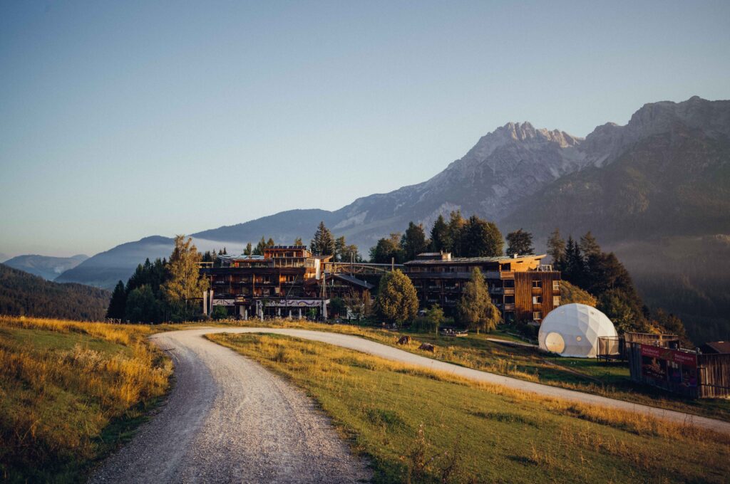 view of a hotel against the backdrop os a mountain
